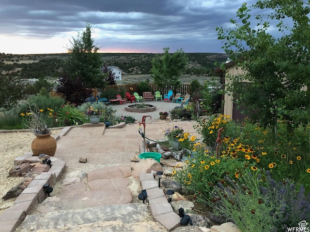 patio terrace at dusk with an outdoor fire pit