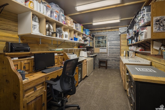 carpeted home office with wood walls