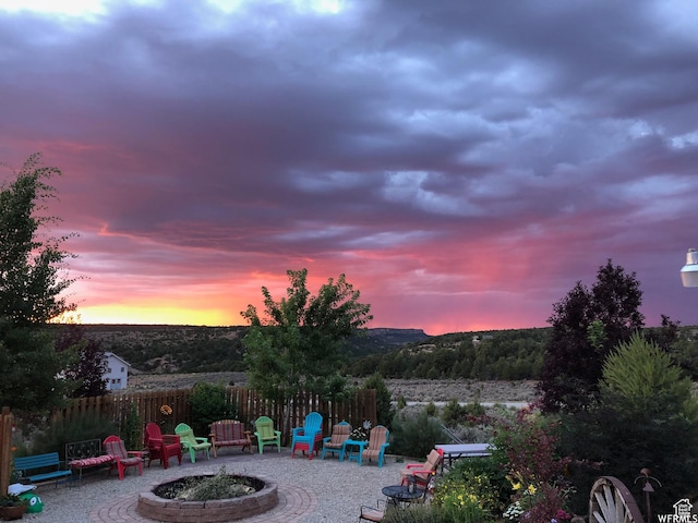 patio terrace at dusk featuring a fire pit