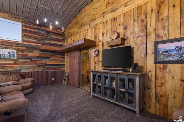 carpeted living room with wood walls and vaulted ceiling