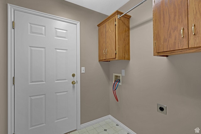laundry room featuring electric dryer hookup, hookup for a washing machine, and cabinets
