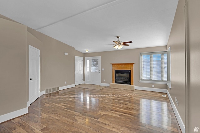 unfurnished living room featuring a fireplace, hardwood / wood-style floors, ceiling fan, and lofted ceiling