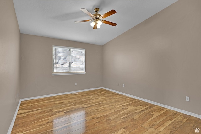 empty room with ceiling fan and light hardwood / wood-style flooring