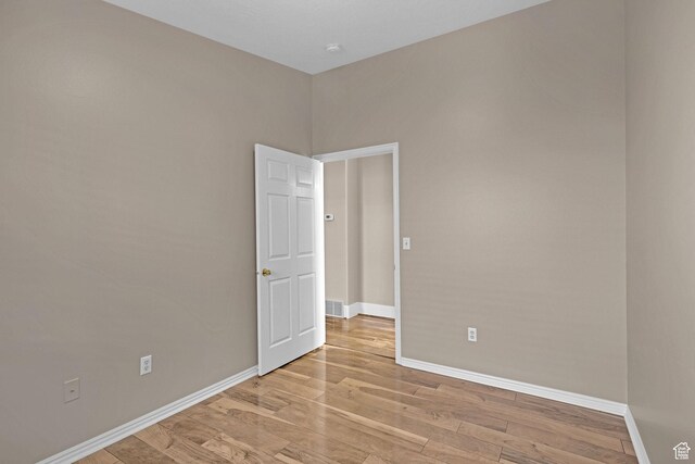 spare room featuring light hardwood / wood-style floors