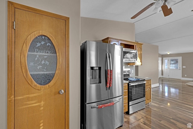 kitchen featuring ceiling fan, appliances with stainless steel finishes, and light hardwood / wood-style flooring