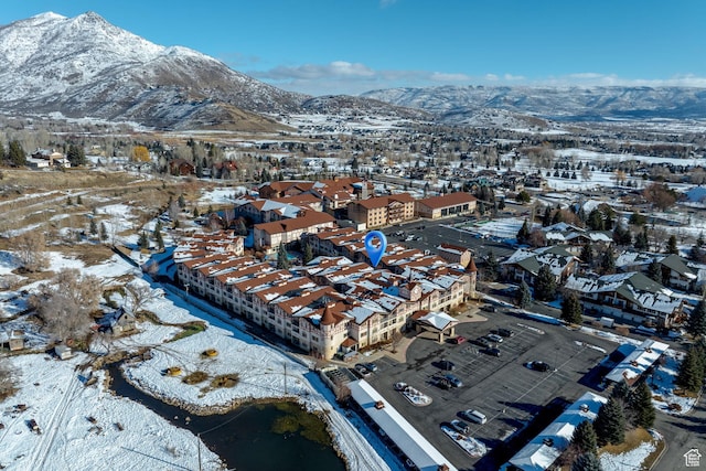snowy aerial view with a mountain view