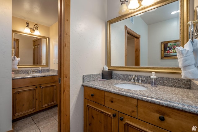 bathroom with tile patterned flooring and vanity