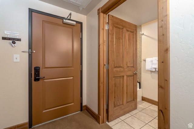 hallway featuring light tile patterned floors