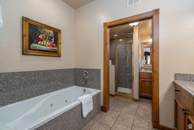 bathroom with tile patterned floors, vanity, and independent shower and bath