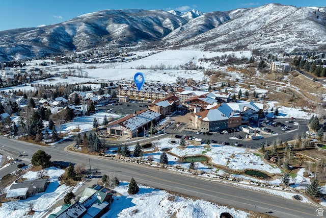 snowy aerial view with a mountain view