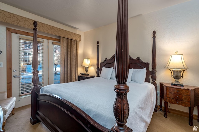 bedroom with light carpet and access to outside