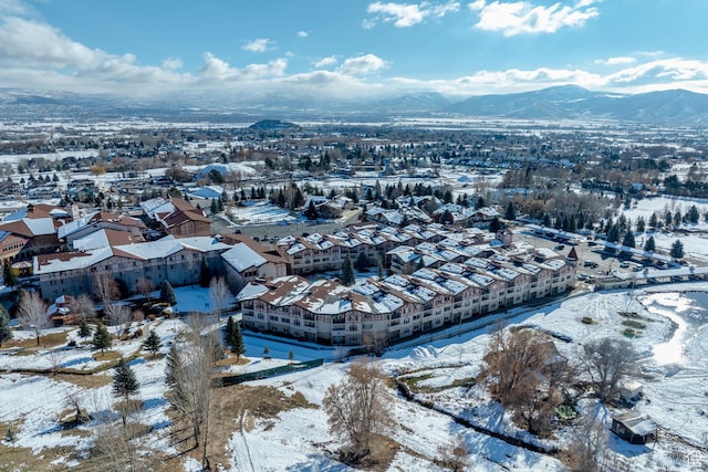 snowy aerial view with a mountain view