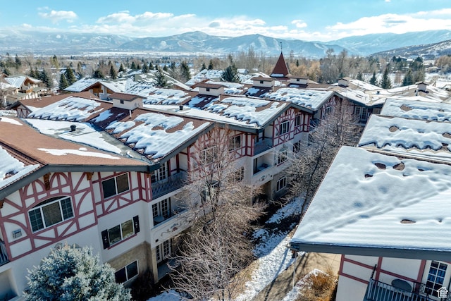 snowy aerial view featuring a mountain view