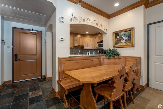 dining space featuring crown molding