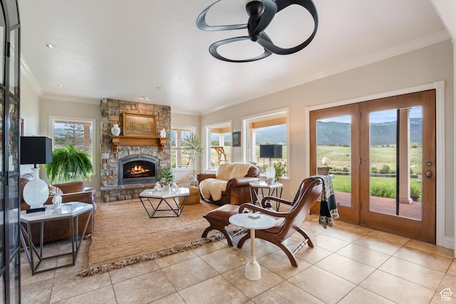 650 E 600 S, Spring City, UT 84662 - living room featuring light tile patterned floors, a ceiling fan, a stone fireplace, ornamental molding, and a mountain view