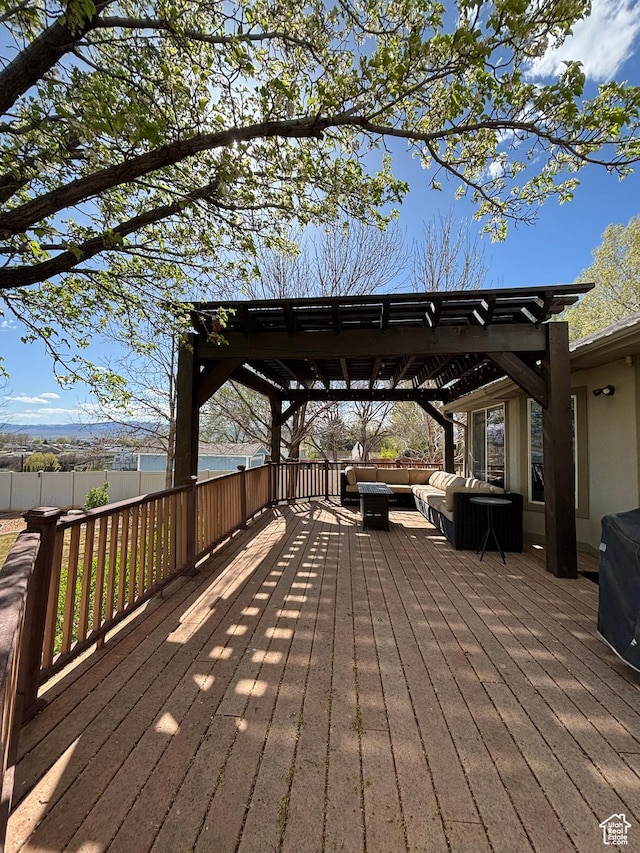 deck with a pergola, an outdoor hangout area, and fence