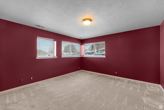 3893 S Bountiful Blvd, Bountiful, UT 84010 - unfurnished room featuring a healthy amount of sunlight, carpet flooring, a textured ceiling, and visible vents