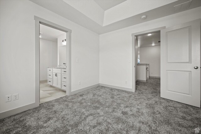639 S 85 E Unit 28, Smithfield, UT 84335 - unfurnished bedroom with light carpet, connected bathroom, baseboards, and a sink
