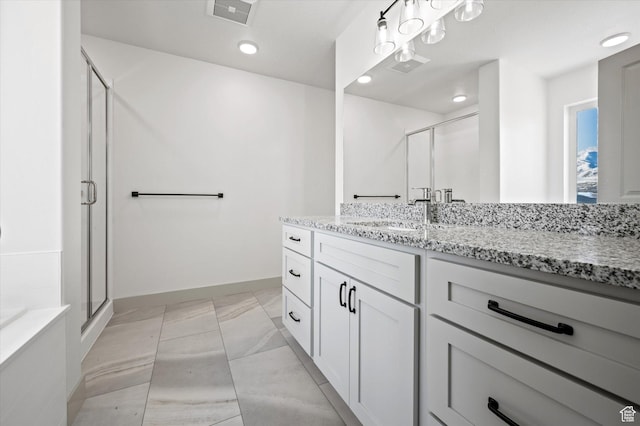 639 S 85 E Unit 28, Smithfield, UT 84335 - full bathroom with visible vents, marble finish floor, a stall shower, baseboards, and vanity