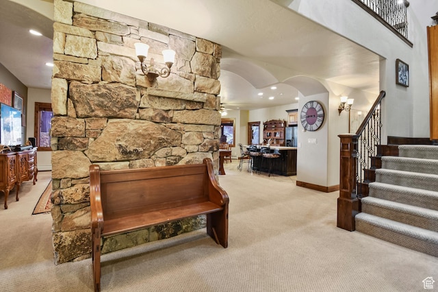 interior space featuring light carpet and ceiling fan