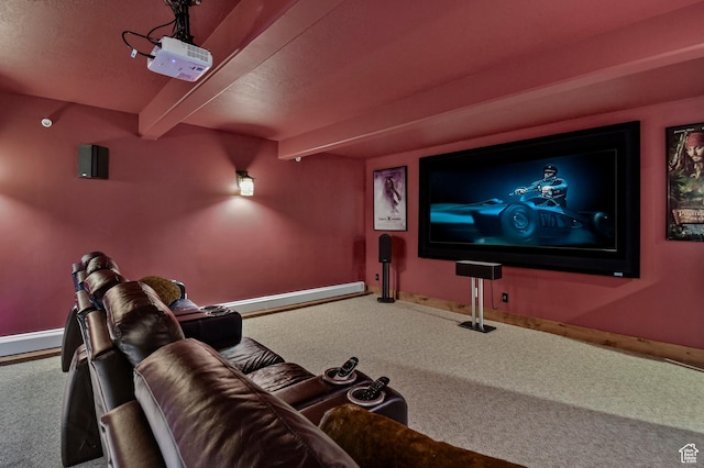 cinema room featuring beam ceiling and carpet floors