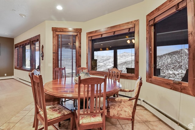 tiled dining room with baseboard heating and a mountain view