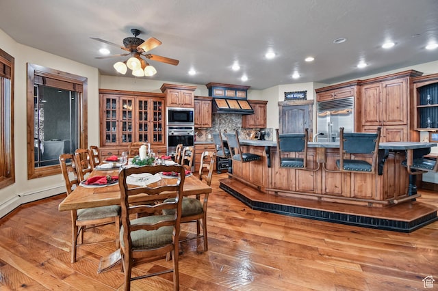 dining room featuring ceiling fan and light wood-type flooring