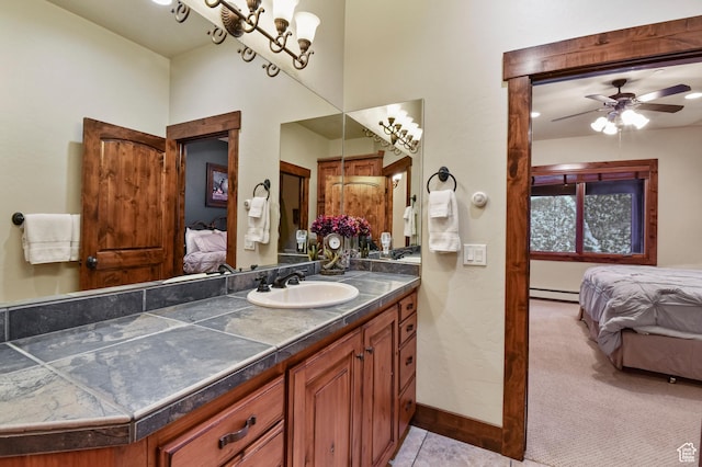 bathroom with vanity, a baseboard radiator, and ceiling fan with notable chandelier