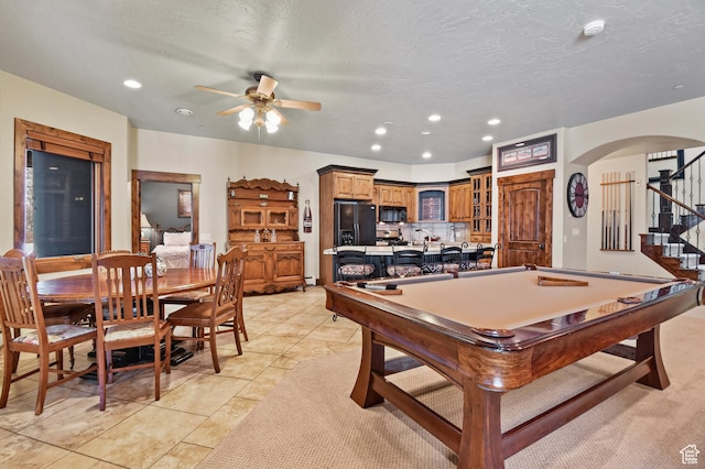 game room featuring light tile patterned floors, a textured ceiling, ceiling fan, and pool table