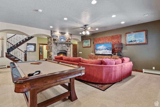 rec room with ceiling fan, billiards, light colored carpet, a textured ceiling, and a fireplace