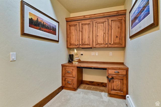 carpeted office space with a baseboard heating unit