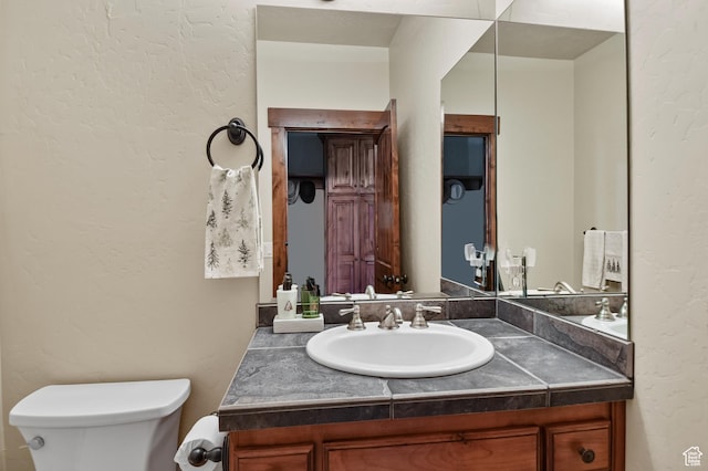 bathroom featuring vanity and toilet