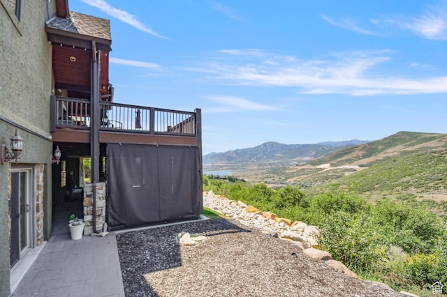 view of yard featuring a deck with mountain view