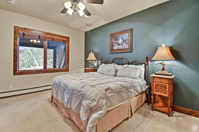 carpeted bedroom featuring ceiling fan and a baseboard heating unit