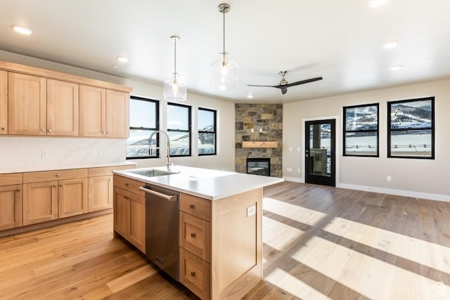 1166 W Helling Cir Unit 203, Heber City, UT 84032 - kitchen with pendant lighting, dishwasher, a center island with sink, a stone fireplace, and sink