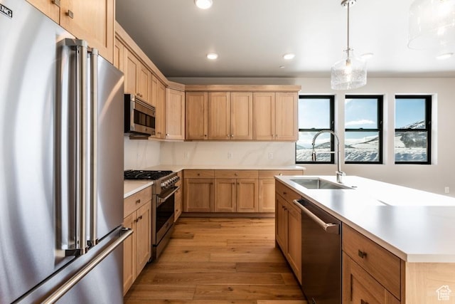1166 W Helling Cir Unit 203, Heber City, UT 84032 - kitchen featuring high end appliances, sink, tasteful backsplash, decorative light fixtures, and light wood-type flooring