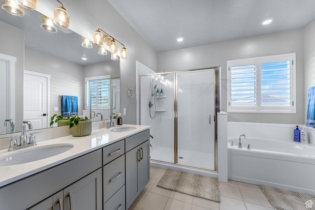 2217 E Emerald Ave, Eagle Mountain, UT 84005 - bathroom featuring tile patterned floors, a stall shower, a bath, double vanity, and recessed lighting