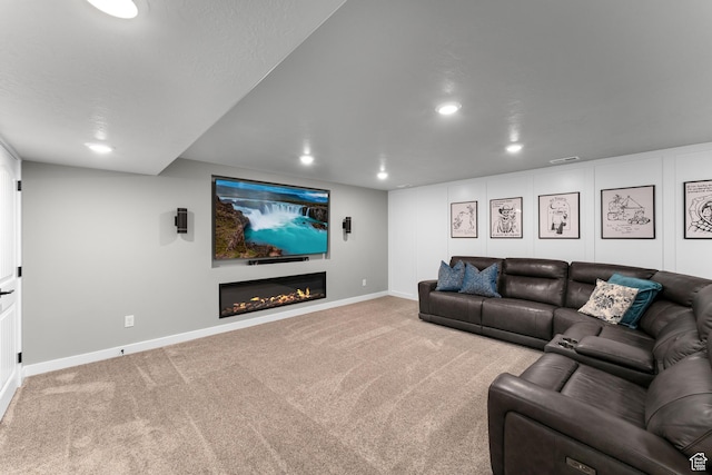2217 E Emerald Ave, Eagle Mountain, UT 84005 - living area featuring recessed lighting, baseboards, carpet flooring, and a lit fireplace