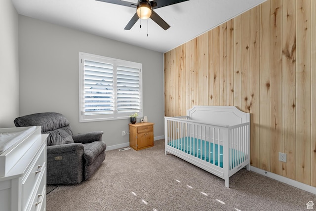 2217 E Emerald Ave, Eagle Mountain, UT 84005 - carpeted bedroom featuring wooden walls, baseboards, a nursery area, and a ceiling fan