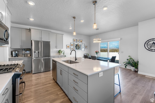 2217 E Emerald Ave, Eagle Mountain, UT 84005 - kitchen featuring a sink, appliances with stainless steel finishes, gray cabinetry, light countertops, and recessed lighting