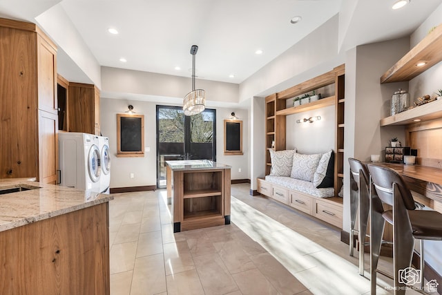 2523 N Chaco Trl, St George, UT 84770 - kitchen with open shelves, washing machine and clothes dryer, built in shelves, light stone counters, and baseboards