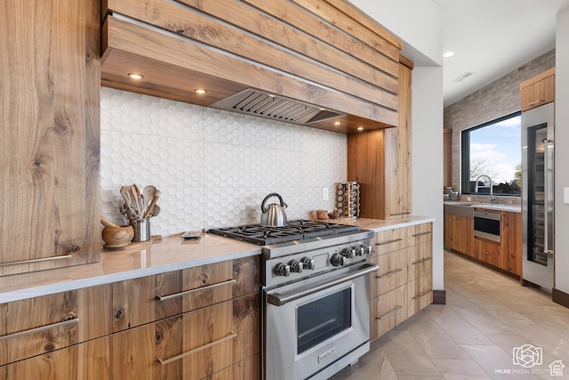 2523 N Chaco Trl, St George, UT 84770 - kitchen featuring premium appliances, custom range hood, decorative backsplash, a sink, and modern cabinets