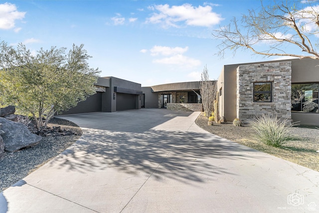 2523 N Chaco Trl, St George, UT 84770 - contemporary home featuring stucco siding, stone siding, an attached garage, and driveway