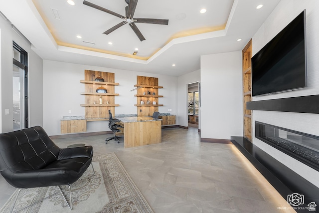 2523 N Chaco Trl, St George, UT 84770 - office space featuring a tray ceiling, recessed lighting, a large fireplace, ceiling fan, and built in study area