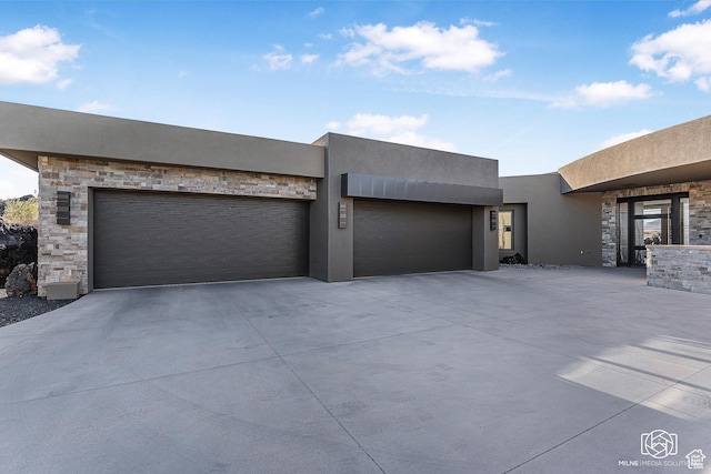2523 N Chaco Trl, St George, UT 84770 - contemporary home with concrete driveway, stone siding, a garage, and stucco siding