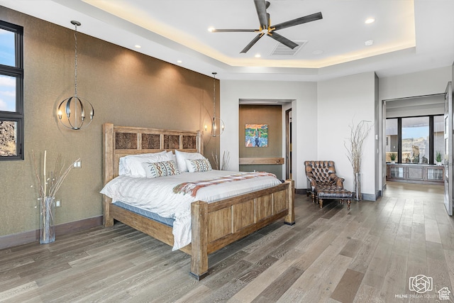 2523 N Chaco Trl, St George, UT 84770 - bedroom with a raised ceiling, wood finished floors, baseboards, recessed lighting, and a chandelier