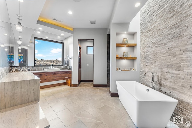2523 N Chaco Trl, St George, UT 84770 - full bathroom with a freestanding bath, vanity, recessed lighting, built in shelves, and baseboards