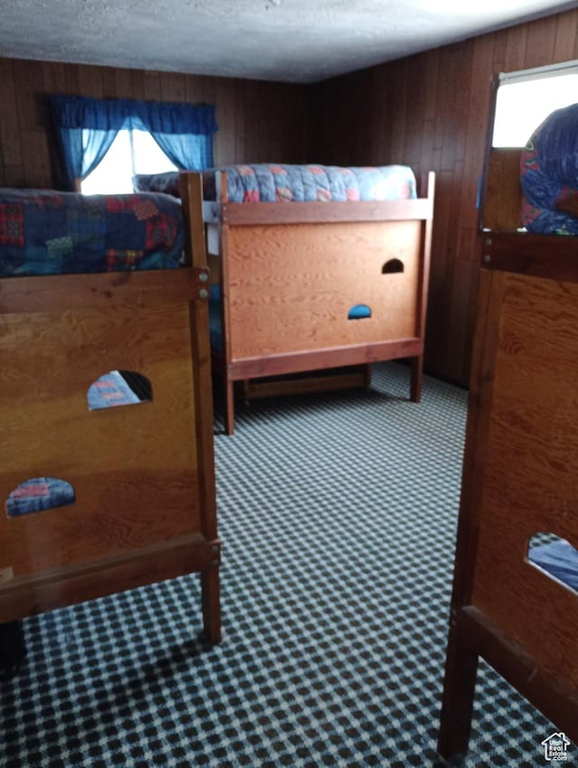 80 S Chipper Ln, Manila, UT 84046 - bedroom featuring carpet floors, a textured ceiling, and wooden walls