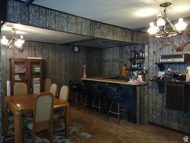 80 S Chipper Ln, Manila, UT 84046 - dining room featuring parquet floors, bar area, an inviting chandelier, and wood walls