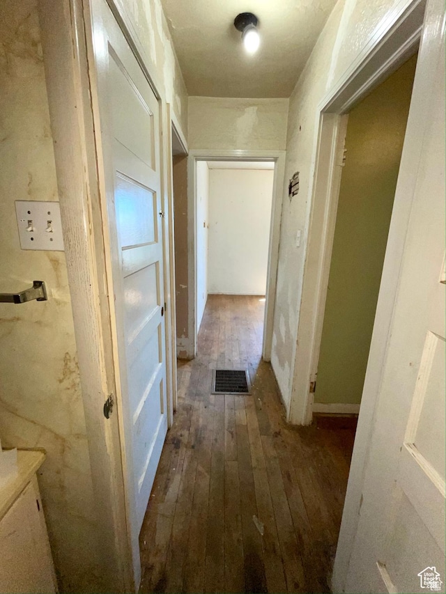 hallway with dark hardwood / wood-style floors